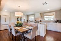 Tile, bench   Joanna Gaines designed the kitchen island with dining table and booth seating attached.