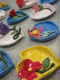 Steiner Ranch Elementary 4th grader ceramic heart shaped dishes with roses and flowers, approx. 6"--8" wide; art teacher: Susan Joe