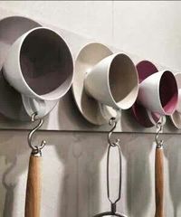 Great idea using tea cups for utensils or such on wall