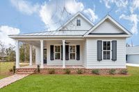 The brick-clad base and front porch add to the immense curb appeal offered by this 3-bedroom Southern Cottage home plan, which is exclusive to Architectural Designs.The wraparound porch invites you inside where an open living area connects with the dining space and kitchen.A 9