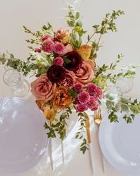 The "Just Like Heaven" collection features rich tones of plum, mauve, dusty pink, and a touch of gold. Roses, ranunculus, cushion poms, lisianthus, pearl acacia, and eucalyptus add the perfect romantic touch to a jewel-toned or mauve wedding.