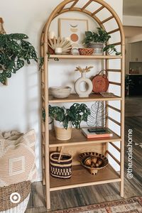 A curved wooden shelf is a versatile add-on to small spaces. The arching ladder detail gives this bookshelf an airy look to store & display without looking bulky.