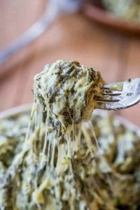 Morton's Steakhouse Creamed Spinach (Copycat) is a decadent side ready in minutes, with fresh spinach, butter, garlic, and three cheeses. A perfect vegetarian side dish for the holidays.