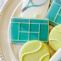 "The player who serves well seldom loses." This decorated cookie set is sure to be the jumpstart your favorite tennis player needs! The sugar cookies will come decorated as pictured and will feature an equal mix of tennis ball cookies, racket cookies and court cookies. Individual wrapping is included in the price of the set.