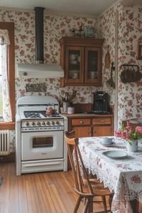 Victorian Farmhouse Kitchen Essentials merge the rustic charm of a farmhouse with Victorian intricacies, including patterned wallpapers, antique wooden furniture, and classic farm implements used as decor. Floral motifs and lace details can add a touch of softness and intricacy, making the kitchen both functional and visually appealing. This style combines the practicality of farmhouse design with the decorative richness of Victorian aesthetics. Find more Victorian farmhouse kitchen decorating ideas by clicking or tapping here.