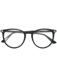 Offering quintessential Italian refinement, these Gucci glasses are instantly recognisable and expertly crafted with immaculate attention to detail. These black circular glasses from Gucci Eyewear feature straight arms with angled tips and an interlocking GG logo. This item comes with a protective case. | Gucci Eyewear Circular Glasses