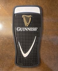 This Guinness Gravity Glass PVC Bar Mat is just like what you would see in an Irish pub as the rubber drip mat under a Guinness beer tap.  A fun cut-out shape of the famous Guinness pint  Measures 7 wide " x 14 long"  Made from PVC Hand wash only