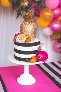 Beautiful Tropical Wedding Cakes -  striped wedding cake with bold blooms and a gilded pineapple