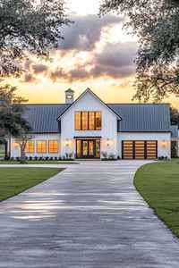 Full frontal view of large white shouse barndominium with black roof one side has modern windows and doors the other side has large garage doors. Unlock the secrets of shouse barndominiums and find out how you can live where the wild west meets modern luxury.