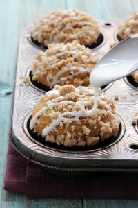 Moist spiced pumpkin muffins with a streusel topping and vanilla glaze. The perfect Fall breakfast or snack!