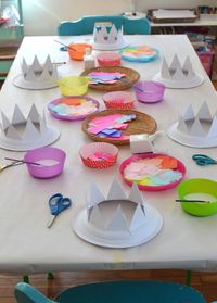 Paper plates are cut into crowns for children to collage into party hats.