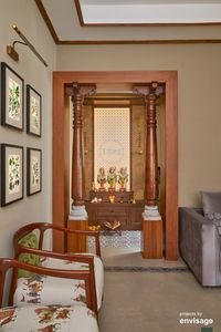 The most divine space of the house is located on the first floor besides the family room in earthy tones and textures. The overall theme of the story is based on "The Ramayana House", where the pooja room depicts the 'Sundar Kaand'. Adorned with two intricately carved Chettinad pillars along the doorway and patterned motif tiles flooring on the inside of pooja room flooring.  ~The Ramayana House by envisage  #envisageinteriors #interiordesign #interiordecor #indianinteriors #indianhomedecor #poojaroom #temple