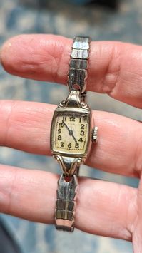 "This is a beautiful Elgin ladies watch that is currently working! I am not a watch expert, nor have I had it tested or serviced, it is being sold AS IS. I've wound it several times and it keeps fairly good time, not perfect, but ok.  I would strongly recommend having it serviced by a professional. The face is a rectangle with a pearly white face and black hands and numerals. The watch is marked 10k RGP on the back. This watch is approximately 6.5\". There is a chip in the crystal in the upper r