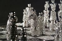 Royal Diamond Chess Set "The Royal Diamond Chess" entirely hand-made in 14-carat white gold set with approximately 9900 black and white diamonds is an extraordinary luxurious version of the classic chess-set. Designed by the renowned French artist designer and master of jewelry Bernard Maquin and as part of the Charles Hollander Collection "The Royal Diamond Chess" is a rare and precious work of fine art jewelary. This entirely hand-made creation is an expression of meticulous artisanship. W...