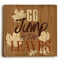 This Jump In The Leaves wood sign by Artist Misty Diller adds a festive style to your fall decor.