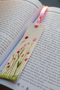 This bookmark is made up of hand-drawn and watercolor artwork featuring a set of flowers*. The artwork has been treated with a clear, permanent protective layer. Choosing the flower color will determine which design you will receive. There are pink flowers, blue flowers, purple flowers, and two different styles of yellow flowers. *Note: each bookmark is handmade. The design will be the same but small differences may occur.