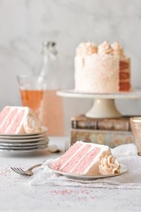 Perfect for Valentine's Day, this pretty pink champagne cake is as delicious as it is lovely to look at! Pink champagne in the cake and buttercream adds the most wonderful flavor and texture, and the cake is finished with a sprinkling of sparkling sugar. A high altitude tested cake recipe.