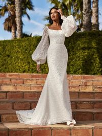 Beaded pearl and sparkle tulle fitted bridal gown with detachable bishop sleeves. Sampled in a bridal sizes 10 and 20, orderable in sizes 2-28.