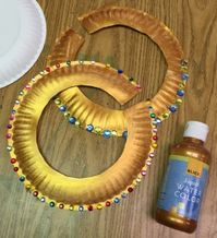 One more paper plate project – Egyptian collar jewelry. Students cut out the center, painted it with Dick Blick gold watercolor, and glued some plastic rhinestones when dry. An easy way to start a cos