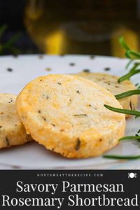 Fresh rosemary, parmesan cheese, and loads of fresh cracked black pepper make this savory Parmesan Rosemary Shortbread the perfect cocktail appetizer or snack. #holidays #recipe #coctails #cookies