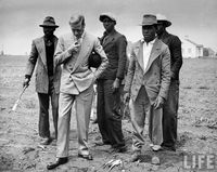 1943 – The Governor of the Bahamas, Duke of Windsor, visiting with Bahamian farm laborers during WWII. — Photograph by Peter Stackpole for LIFE