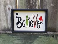 Believe Christmas sign, Grinch décor, Holiday sign, Christmas wood sign, Farmhouse style rustic home décor, Tiered Tray decor, Shelf sitter This small, engraved wood sign would make the prefect addition to any Christmas décor display! The words and images are carved into the wood. It is then hand painted, framed with a black frame, and then finished with a clear coat to protect it from scratches and dents. It will balance on its own no additional support is necessary.    Measures 8x5 inches  Ple