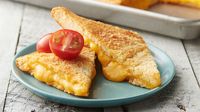 This is how you do grilled cheese for a crowd! Crescent dough is brushed with seasoned butter and stuffed with gooey cheese as an easy way to serve your favorite grilled cheese sandwich as a main meal (or cut into smaller portions for cheesy appetizers).