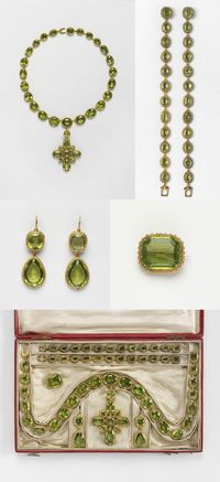 Set of gold and peridot jewels, composed of a necklace with pendent cross, two bracelets, two earrings and brooch. They are contained in a red leather case and have survived with a letter from Princess Elizabeth. Periodot mounted in gold, with gold pin. On 30 April 1816 the Prince Regent, the future George IV, sent to ‘Miss Coats’ a set of peridots to wear at the marriage of his daughter, Princess Charlotte, and Prince Leopold of Saxe-Coburg.