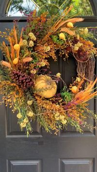 Luxury, rustic, woodsy fall wreath for front door featuring a golden mustard yellow variegated pumpkin, and full of fall greenery, pods, pine cones, deep burgundy and beige faux florals and twigs. This woodsy design is perfect for Thanksgiving. Perfect for your front door, porch, over your mantle or on your wall It makes a great gift! Finished size is approximately 25”w x 22”h x 7”d