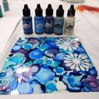 Using alcohol inks on clear plastic with craft punches to make your own translucent embellishments. Stained glass effect for card making project.