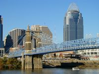 The John A. Roebling Suspension Bridge (formerly the Cincinnati-Covington Bridge) is a suspension bridge that spans the Ohio River between Cincinnati, Ohio, and Covington, Kentucky. When opened on December 1, 1866, it was the longest suspension bridge in the world at 1,057 feet (322 m) main span, which was later overtaken by John A. Roebling's most famous design of the 1883 Brooklyn Bridge at 1,595.5 feet (486.3 m). Pedestrians use the bridge to get between the hotels, bars, restaurants, and parking lots in Northern Kentucky. The bar and restaurant district at the foot of the bridge on the Kentucky side is known as Roebling Point.