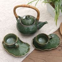 Tea for two is a peaceful affair with Balinese artisan Nyoman Suarmini's lovely green tea set. Hand crafted from ceramic the set includes one teapot with a bamboo handle two cups and two leaf-themed saucers. The set's glossy green glaze will put you at ease as you enjoy your next cup with a friend.