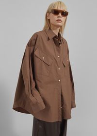 Color: Brown Lightweight cotton blend fabric Oversized fit Pointed collar Drop shoulders Asymmetrical front flap pockets Button cuffs Front button closure Unlined 100% Cotton Dry Clean By The Frankie Shop. Imported