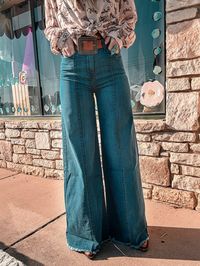 Classic trouser style jeans with front seam detail Stretchy material and keeps it's shape Frayed hem and extra wide leg style Inseam: 35" Fit true to size 98% Cotton 2% Spandex Model is wearing a size 27 and is a size 4/6 or a size 28 and 5'8" SPU:BMCJ24110111