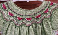 Bishop style, hand-smocked dress embroidered with watermelons. Has angel sleeves and delicate lace . Available in size 18-24M and 2T For custom made allow 2-3 weeks for delivery.