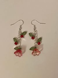 'Blooming Beauty' handmade dangling earrings, perfect for valentine's day!  These gorgeous flower earrings are available in multiple colours and are bound to be gratefully received by your partner, bestie, or even as a gift to yourself this v-day.  The Blooming Beauties are decorated with two small bead and leaf charms, as well as a statement flower and leaf at the end of the chain.  Colours may vary in quantity and price.  All orders are highly appreciated and made with the most love and care <