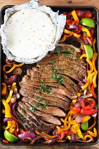 Sheet Pan Steak Fajitas - Tender seasoned flank steak with colorful onions and bell peppers all cooked together on one sheet pan. Restaurant quality fajitas you can have it on the table in about 30 minutes.