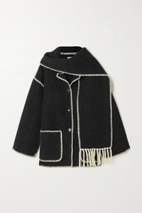 Totême's jacket combines two outerwear essentials with scarf-inspired panels that drape elegantly around your neck. Cut from dark-gray wool, it's outlined by ivory chain stitches and frothy fringe. Button yours up over denim.