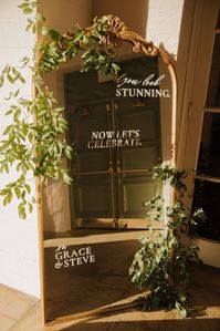 Gold-Frame Mirror Welcome Sign, Custom Text and Ample Greenery