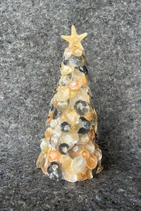 This festive tree would make a beautiful addition to any Christmas decorating. It would also be a great gift for someone special. One of a kind. Made with jingle seashells collected by myself on the beaches of Sanibel Island.