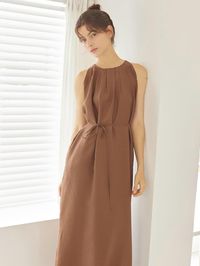 This lightweight dress features halterneck design and sleeveless silhouette. Voluminous tucked details and adjustable waist strap add to the natural, feminine feel. - Lightewight modal blend fabric- Silky, semi sheer texture- Pleated detail for natural mood- Deep slit detail at hem- Refined, sophisticated style