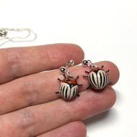 "⭐ I made this Clay insect jewelry, Colorado beetle earrings from polymer clay, painted acrylic paints and covered it with glassy water-based varnish.  ⭐ This cheerful insect will cheer up not only you but everyone around you. ⭐I really wanted it to look as realistic as possible.  ⭐  SIZE: Width  0.47\" ( 1.2 sm) Length 0.59\" ( 1.5 sm) You will love this set because it will make you feel special on any day you choose to wear it! This little Colorado beetle will add a dose of cheer to your choic