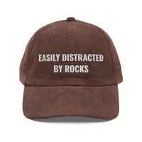 Easily Distracted By Rocks Hat, Geology, Geology Hat, Geology Gifts, Geologist Student, Geology Student Gifts, Vintage Corduroy Cap Hat Step up your style with an embroidered old-school cap. It's crafted from 100% cotton corduroy that's soft to the touch and comfy to wear. It features an adjustable strap with a gold-colored buckle for a great fit and a visor to protect you from the sun and wind. Complete your look with this embroidered corduroy cap and rock a cool vibe all day long. * 100% cotto