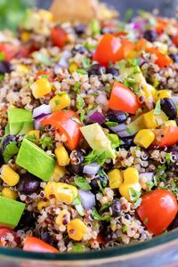 This picnic-worthy Mexican Quinoa Salad gets tossed in a vegan and gluten-free cilantro lime dressing and then loaded with black beans, corn, tomatoes, and avocado.  You can meal prep this side or main dish ahead of time for a quick and easy lunch or dinner recipe, too! #quinoa #salad #mexicanfood