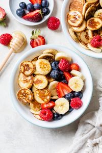 Mini Pancake Cereal is the latest Tiktok trend, so versatile you can serve them with anything you want! I made them healthier with my banana pancake recipe and topped them with tons of fresh fruit. #pancakecereal