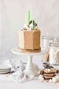 This made-from-scratch s’mores ice cream cake features layers of graham cracker crust, ganache, homemade no-churn ice cream, whipped cream and marshmallow fluff. You’ll love how fun this cake is to assemble – and eat! It makes a perfect birthday or celebration cake, and is something that even your kids can help with.