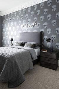 Add wit and whimsy within a monochromatic palette. This teen bedroom from interior designer Nicole Rosenberg of Liberty Interiors is done up in warm and cool tones of gray and silver, with industrial storage, witty wallpaper, and a neon slogan over the bed.