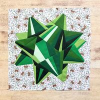 A modern paper piecing quilt block. Gift Bow FPP (Green Version with Kona Color Suggestions) Finished Size: 16" Block Level of Difficulty: Easy/Moderate (2-3) Instant downloadable pattern includes: *Finished Product Image *Mirrored Image for Piecing *Piecing Order Instructions *Pattern pieces--1 set of blank pieces you can write your own numbers on, and 1 set of pieces with color indicators *Color Chart plus Option Kona Color Suggestion List Pattern pieces include 1/4" seam allowance.  All patte