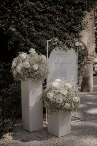 White roses and white gypsophila with white wedding table plan signage | white wedding theme | wedding signs   wedding flower arrangements | Dandelion Studio