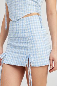 Expertly crafted with a blend of 75% cotton and 25% polyester, this imported gingham mini skirt is both comfortable and stylish. The inner lining of 100% cotton adds a soft touch to the skin, while the trim of 100% polyester adds a subtle touch of elegance. Model is 5'9" and wears a size small.